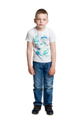 little boy. A life-size portrait. Isolate on white. in jeans and t-shirt