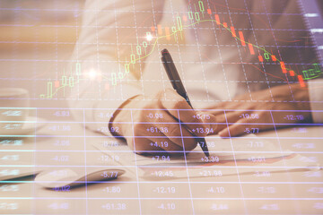 Financial trading chart multi exposure with man desktop background.