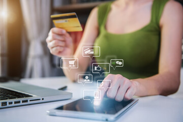 Hands holding credit card and using tablet and laptop computer in office home. Online shopping.