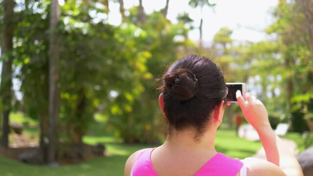 Woman taking picture on the vacations in 4k slow motion 60fps