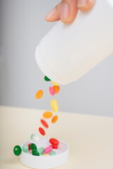 Obraz na płótnie Canvas Many pills capsule spilling out of pill bottle.
