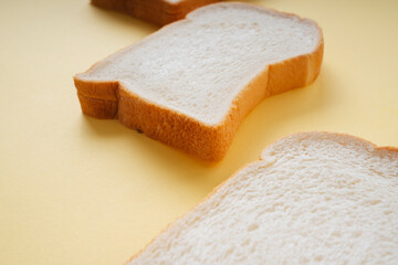 Three sliced bread on yellow floor.