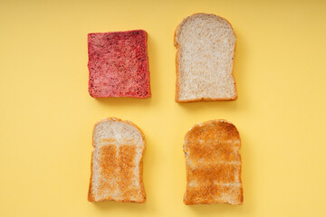 Grill burnt home made organic sliced bread over yellow background.