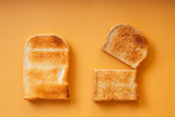 Top view - Grill sliced bread over orange background.