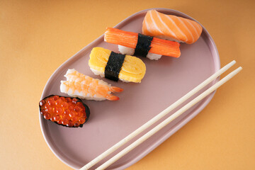 Overhead shot of Japanese sushi set on a plate with chopstick. © THESHOTS.CO