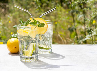 The concept of a summer refreshing drink lemonade from limes and lemons with mint.