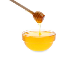 Honey dripping from dipper into bowl on white background