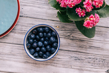 blueberries in a bowl on wooden table