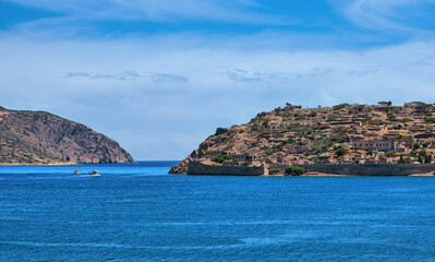 Fototapeta na wymiar View of west bank of Spinalonga island and Venetian fortress on clear sunny summer day, Crete, Greece
