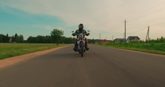 Vintage custom motorcycle riding on a asphalt road