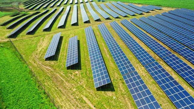 Stunning aerial view of solar panels on green field