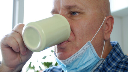 Image with Man Wearing Protection Mask on His Face Drinking a Cup with Coffee