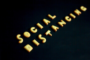 The top-down of the snack is the character, arranged as ideas and concepts about social distancing to protection during the corona virus 2019 disease, on a black background, copy space for text.