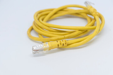 The yellow modem cable rolls in a white scene.