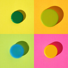 Colorful pattern: four different multi-colored bottle caps metal and plastic on rainbow background, flat lay, hard shadow, square frame.