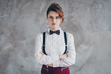 Portrait of her she nice-looking well-dressed attractive lovely chic serious wavy-haired girl folded arms isolated over gray concrete industrial wall background