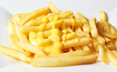 Golden-fried french fries topped with cheese for breakfast or a snack for weight-loss food, but it has a delicious taste, used for wallpaper and text.