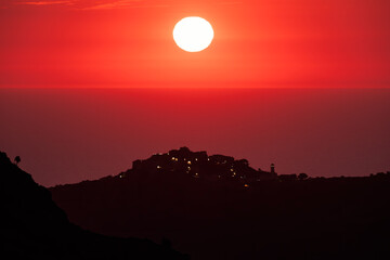Sun setting over the village of Sant'Antonino and Mediterranean