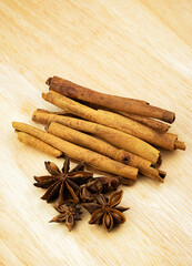 Anise, cinnamon sticks on a wooden table.