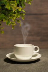 A cup and tea on the table above the sunny mountain landscape nature background