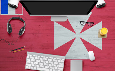 Wallis And Futuna flag background with headphone,computer keyboard and mouse on national office desk table.Top view with copy space.Flat Lay.