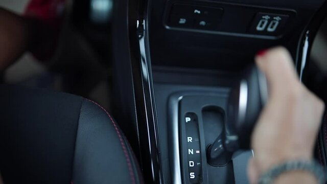 woman driving car moving transmission shift gear.automatic car gear