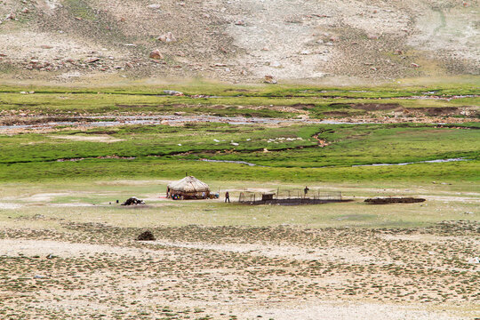 Yurts and tents in Pamir mountains near Pamir Highway in Tajikistan,, Central Asia. Pamir highway is part of an old silk road and leads from Kyrgyzstan to Murghab, Wakhan valley, Khorog and Dushanbe.
