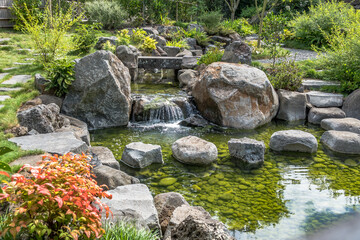 Japanese garden pond with waterfall and bridge - 363824163
