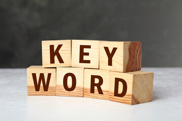 Wooden cubes with word KEYWORD on white table