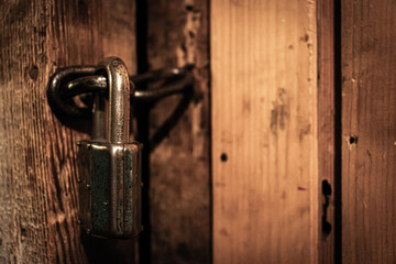 A padlock in the door in the old dark basement