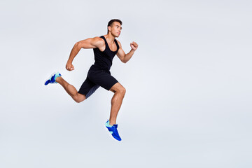 Fototapeta na wymiar Full length body size view of his he nice attractive muscular sportive strong purposeful guy jumping running jogging distance isolated over light gray pastel color background