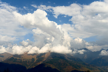 Nature and travel concept - High mountain and sky with clouds in autumn. Beautiful landscape