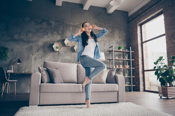 Full length photo of candid charming girl have fun free time wear yellow bright head phones headset listen music enjoy playlist in house indoors