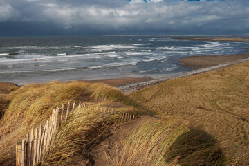 View from a top of a dune on Strandhill beach, county Sligo, Ireland. Atlantic ocean, Blue cloudy sky.