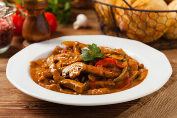 Boeuf, Stroganow, Strogonow. Classic, Russian beef stew. Served on a white plate. Front view. Natural background.