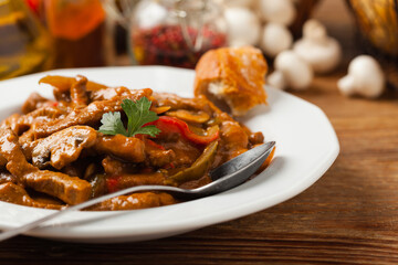 Boeuf, Stroganow, Strogonow. Classic, Russian beef stew. Served on a white plate. Front view. Natural background.