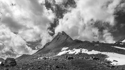 Mountain peak on a dramatic cloudy background, Italian Alps. Monochrome