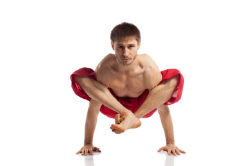 Obraz premium Caucasian adult man doing yoga exercises in studio at white background 