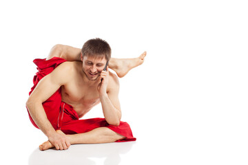 man doing yoga exercises and use mobile phone for message at white background 