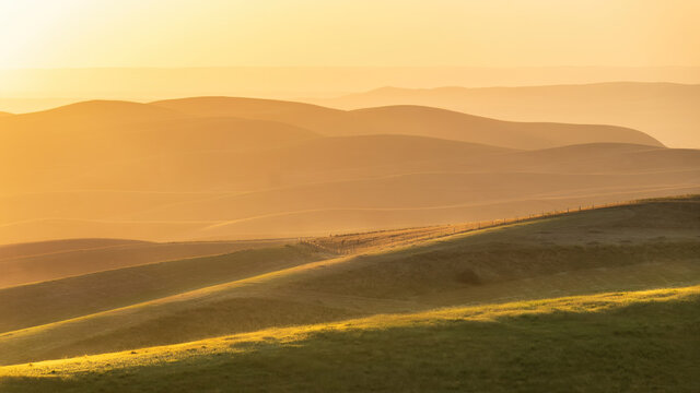 Sunrise or sunset. Inspirational sky background. Calming and relaxing colors and soft light on hills. Sunset landscape in National Park Uzbekistan.