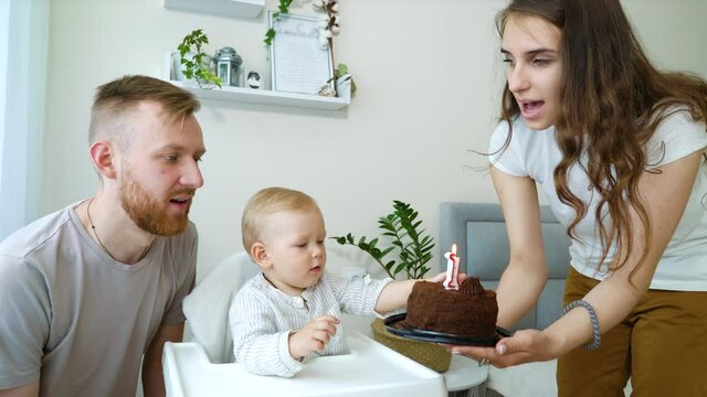 Happy family having first birthday party of baby boy at home