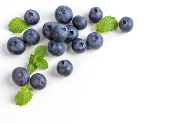 Blueberry fruit top view isolated on a white background, flat lay overhead layout with mint leaf, healthy design concept.