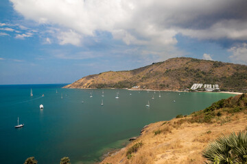 View of beautiful sea which surrounds the hills. There are many white boats in the sea