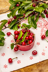 Ripe cherries in bowl and on the branches. Fresh berries, healthy dessert