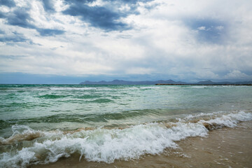 Waves on the beach of Mediterranean sea after storm, Mallorca island, Spain. Holidays in Mallorca. 