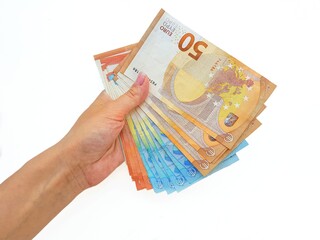 The woman's hand holds the paper money of the euro against a white background.