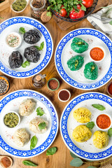 Manti of different colors on a plate with a pattern. Close-up shot in the decor
