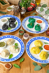 Manti of different colors on a plate with a pattern. Close-up shot in the decor