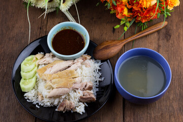 Thai food gourmet steamed chicken with rice , khao mun kai in wood background