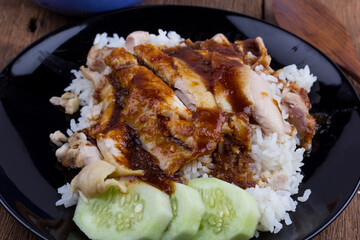 Thai food gourmet steamed chicken with rice , khao mun kai in wood background